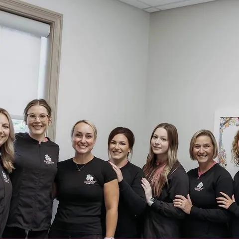 Seven members of the Cactus Pear Dental team standing together in a treatment room