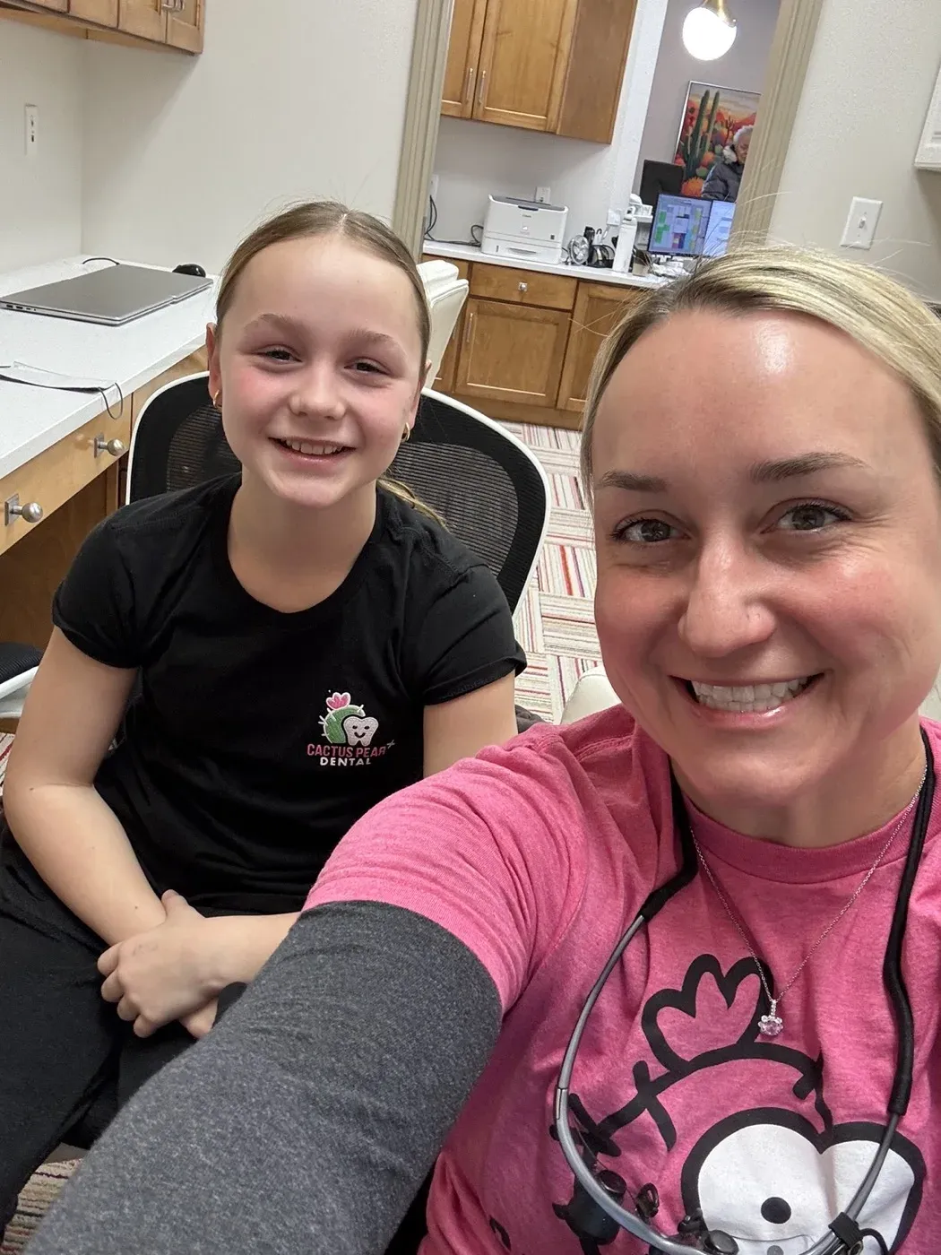 Dr. Oberlander in the office with a young patient in a Cactus Pear Dental shirt