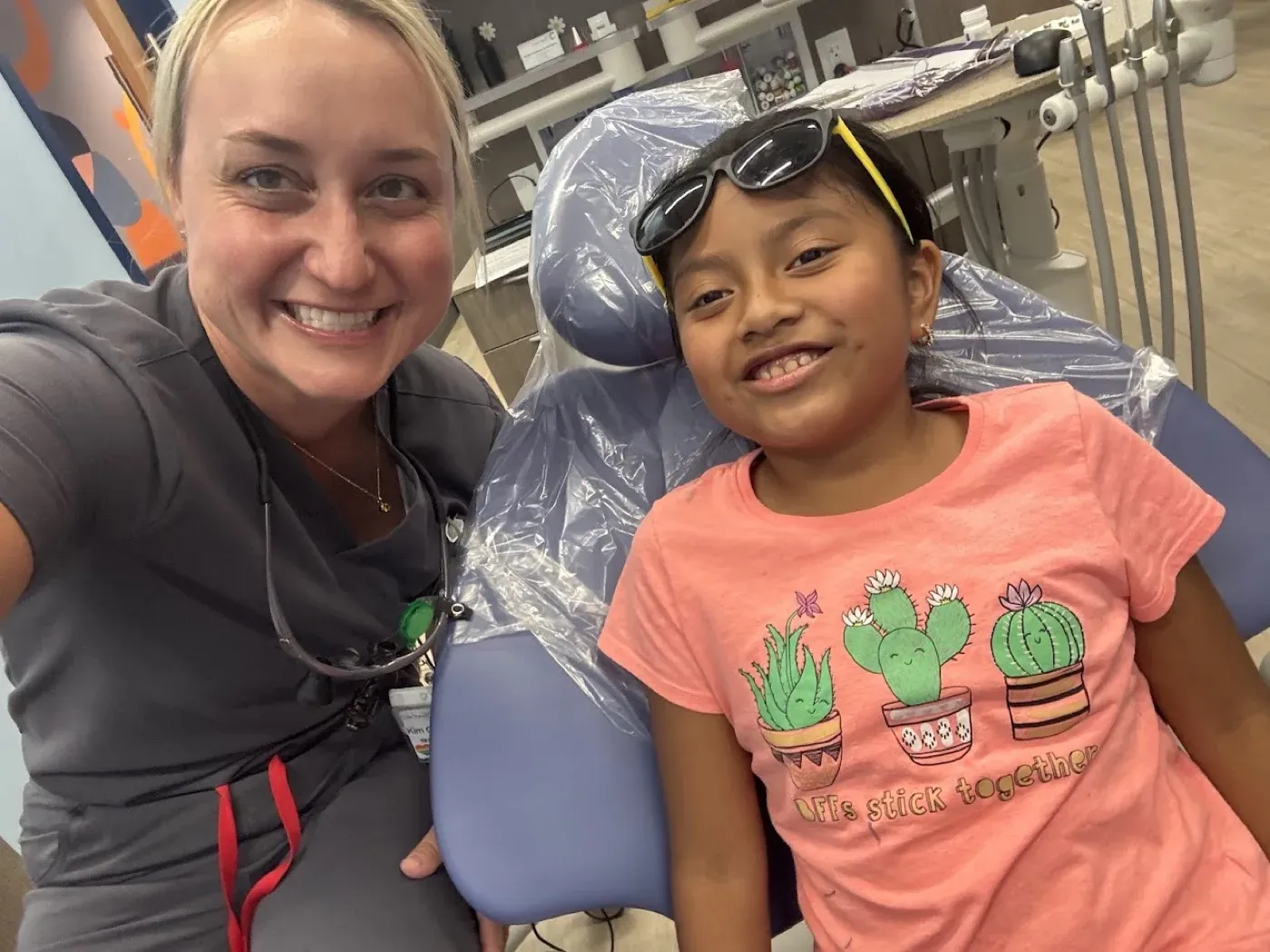 Dr. Oberlander beside a young patient in the treatment chair