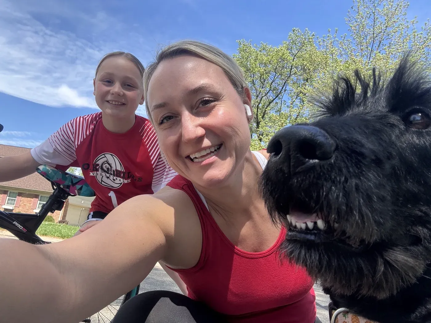 Dr. Oberlander outdoors on a bike ride with a child and a dog