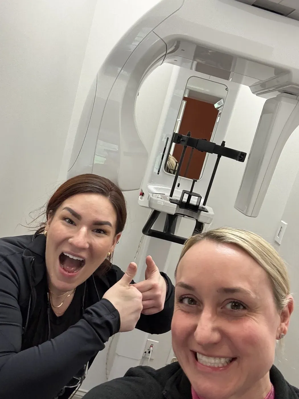 Dr. Oberlander and a colleague beside the panoramic X-ray machine