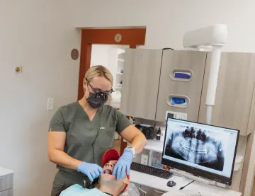 A panoramic dental X-ray displayed on a monitor