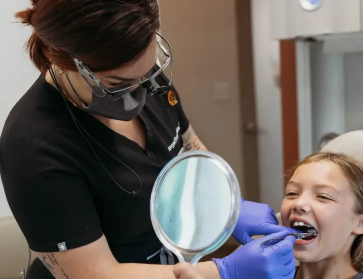 A young patient smiling in the dental chair