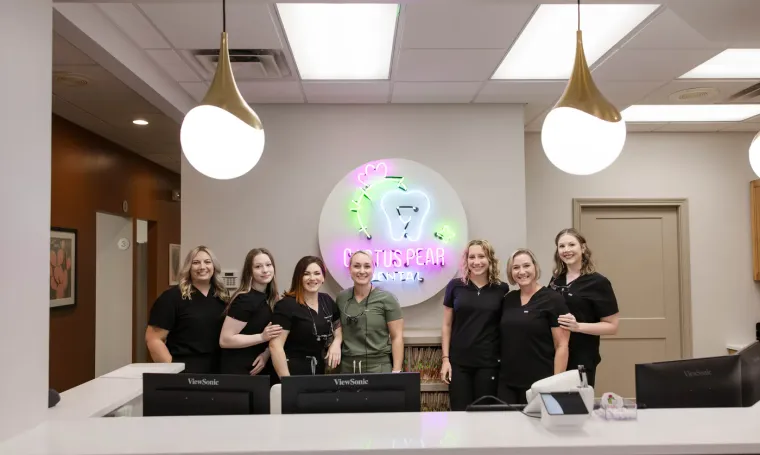 The Cactus Pear Dental team together behind the front desk